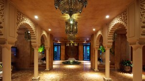 A spacious lobby with ornate arches, a central fountain, and a patterned floor. - Amanda Hotel Kenting (Hengchun)