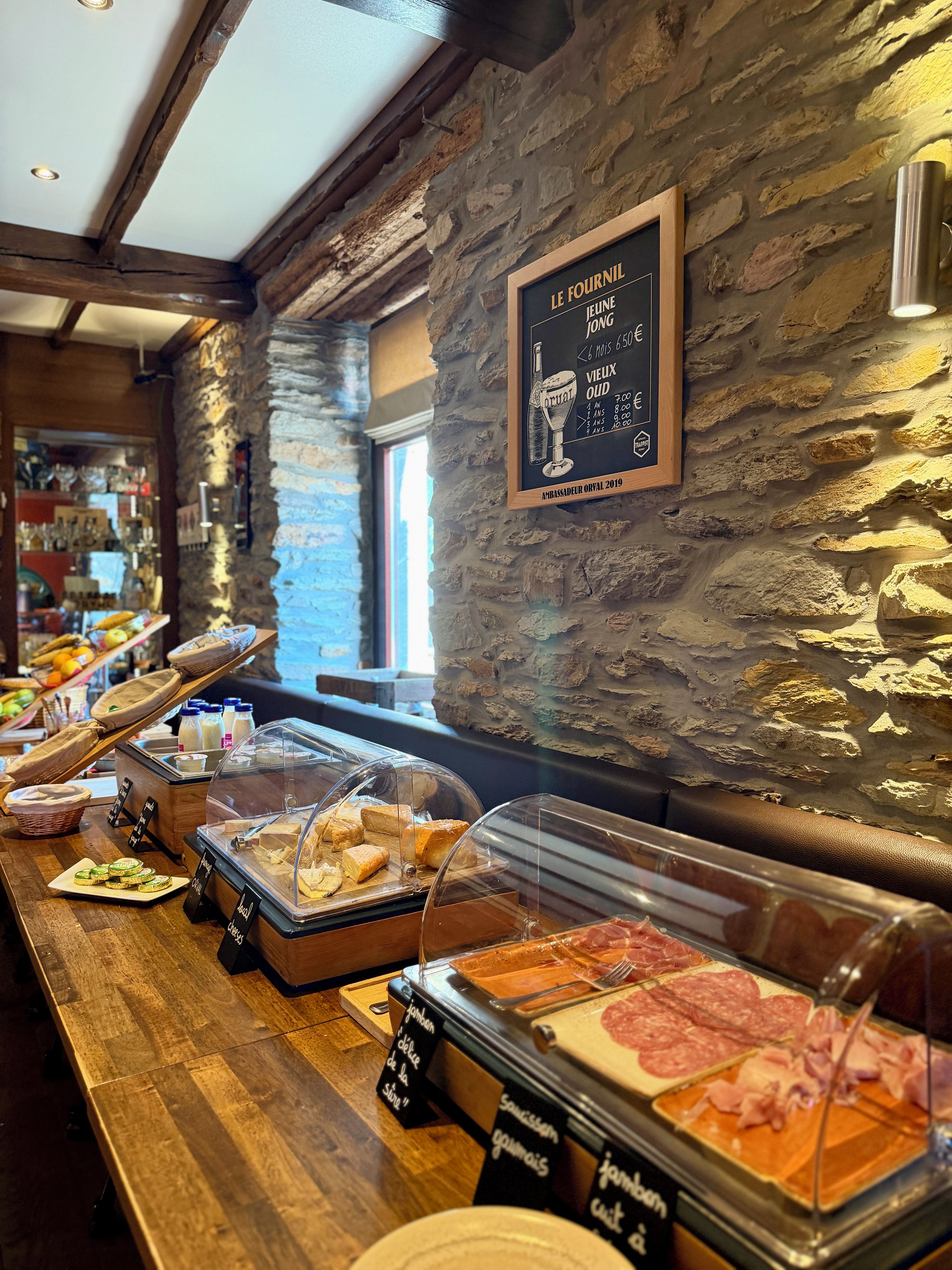 A breakfast buffet with various food items and a chalkboard menu.