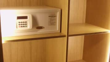 A hotel room with a built-in minibar and a wooden panel wall.