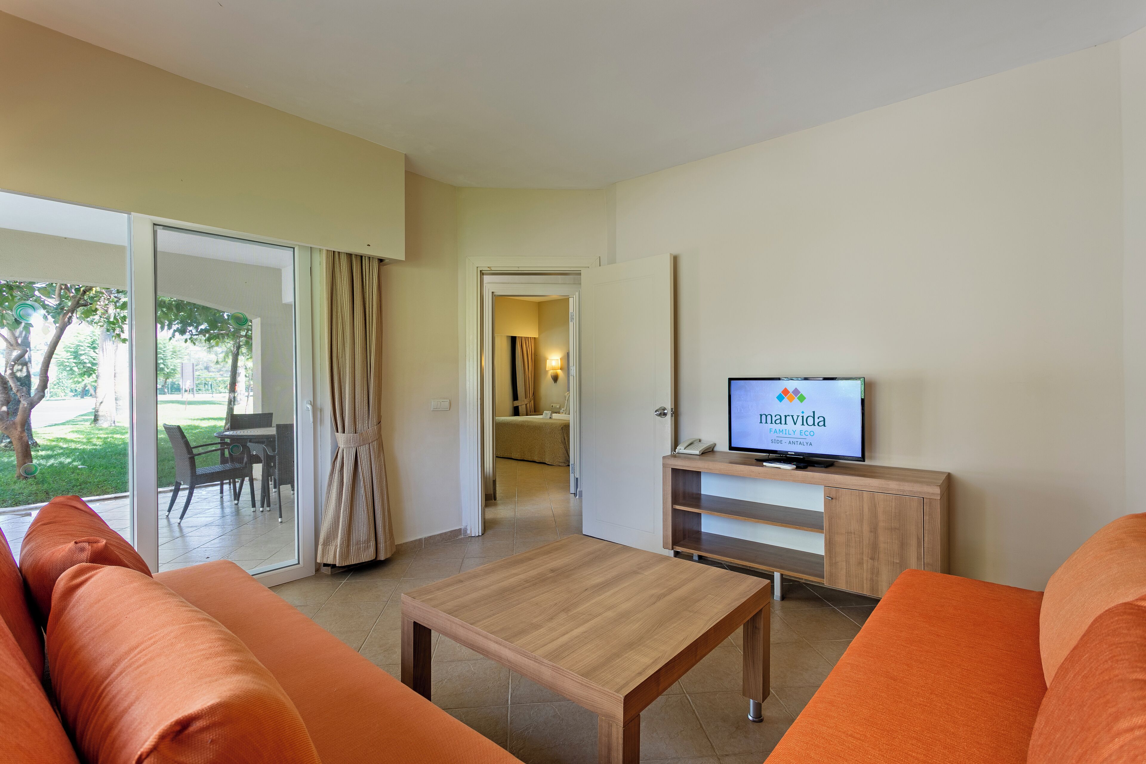 Een moderne woonkamer met een bank, salontafel en televisie.