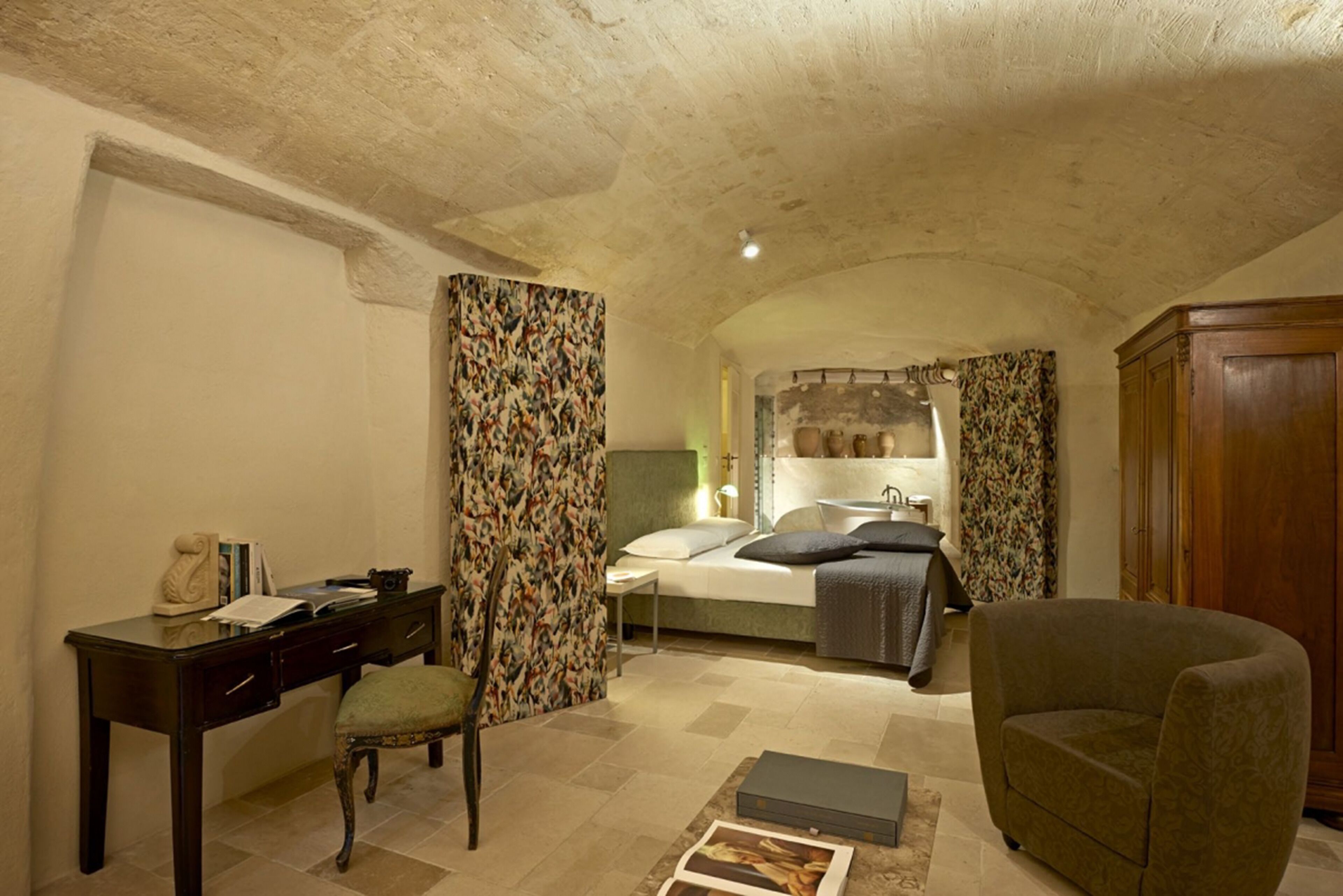 A bedroom with a bed, a desk, a chair, and a wardrobe.