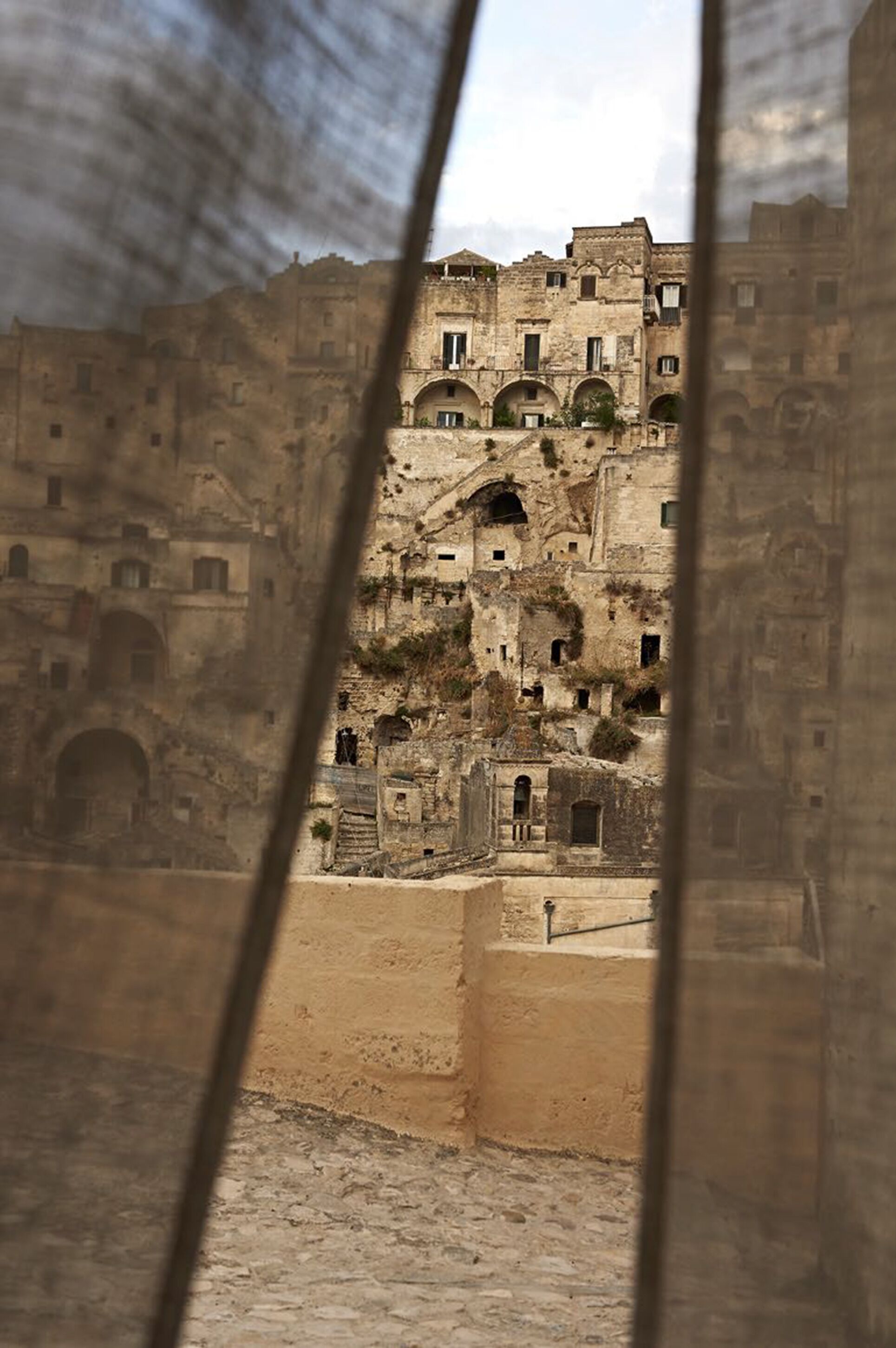 An ancient stone building with multiple levels and arched doorways.
