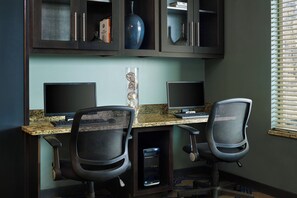 A workspace with two desks, chairs, and a computer setup. - Four Points by Sheraton Williston (Williston)