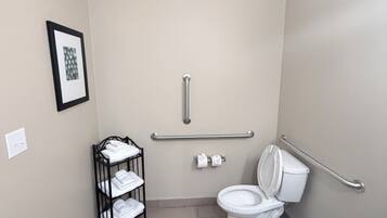 A small, single-occupancy bathroom with a toilet, a sink, and a towel rack.