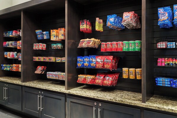 A grocery store with shelves stocked with various snacks and beverages.