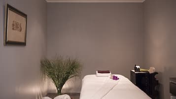 Experience a serene retreat with a large bed, a nightstand, and a potted plant.