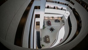 A modern interior with a circular atrium, multiple levels, and a central seating area. - Nobile Hotel Convention Ciudad Del Este (Ciudad Del Este)