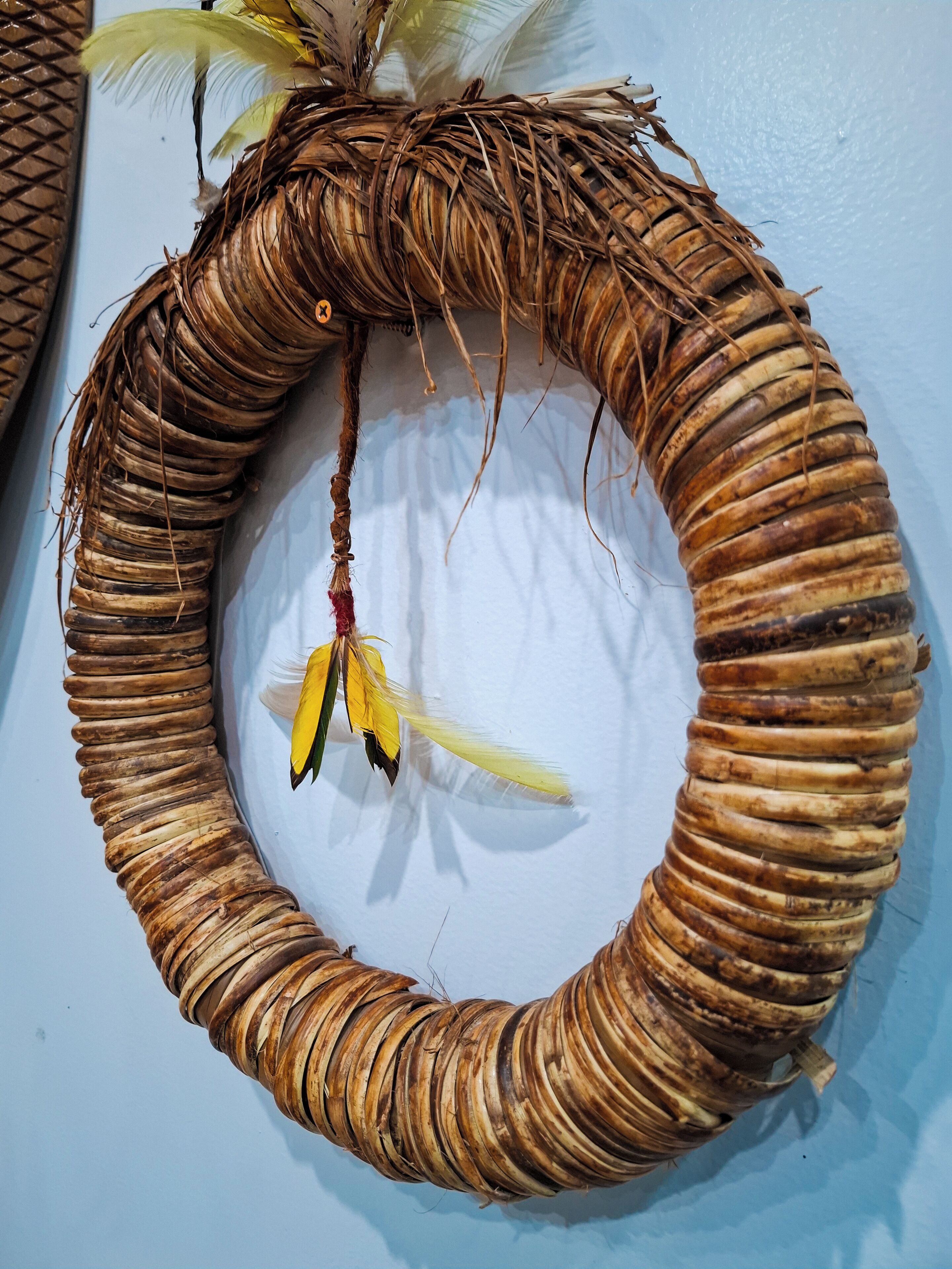 A circular woven structure with a hanging decoration.
