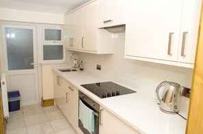 Full-sized fridge, microwave, stovetop, coffee/tea maker