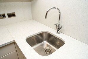 Full-size fridge, microwave, stovetop, coffee/tea maker