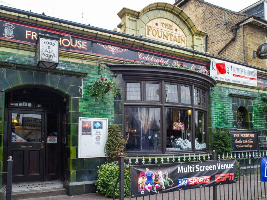 A building with a sign for "The Fountain" and "Food & Ale House".