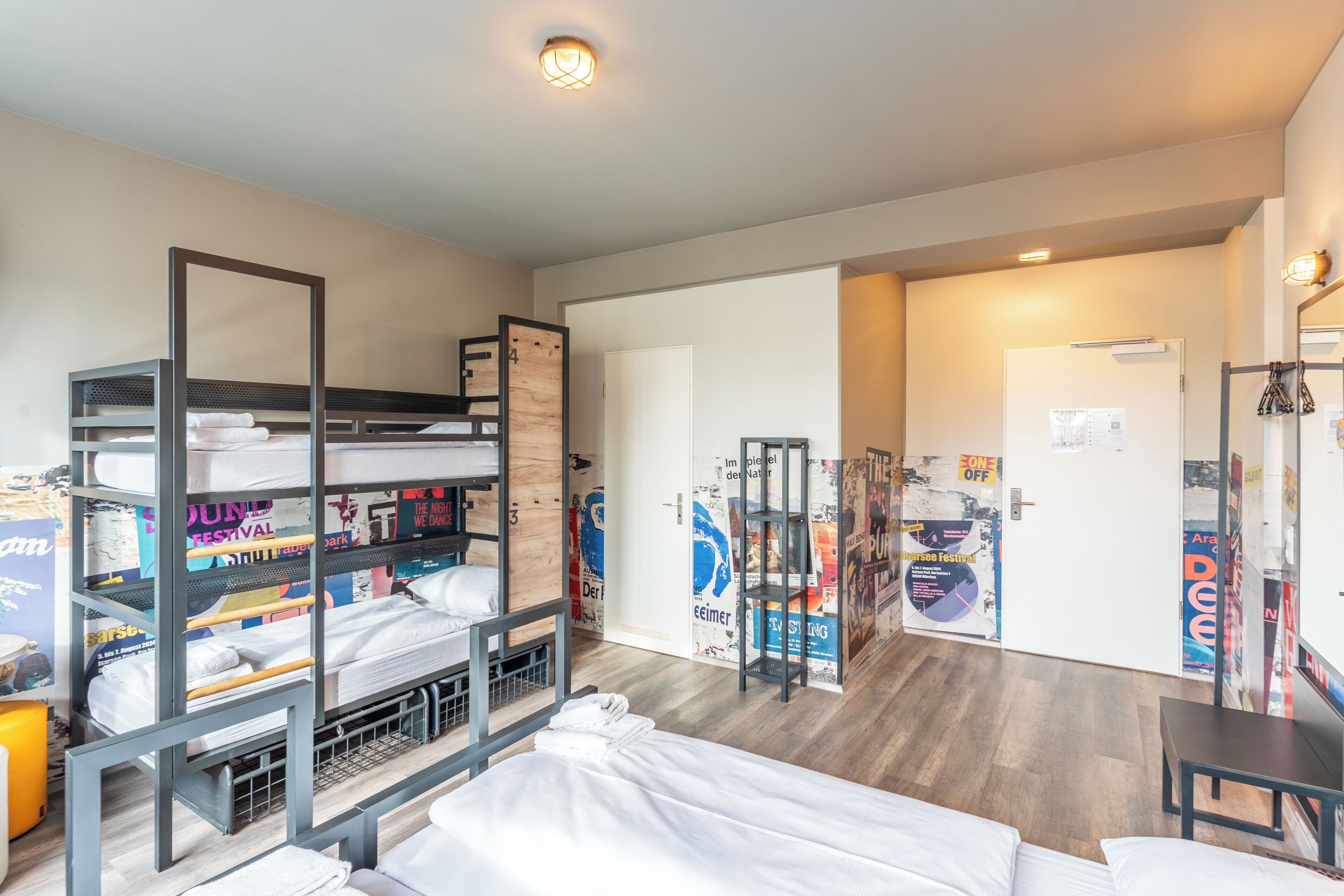 Habitación tipo dormitorio con literas, un escritorio y un armario.