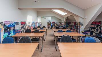 A modern library with bookshelves, tables, and chairs arranged for reading and studying.
