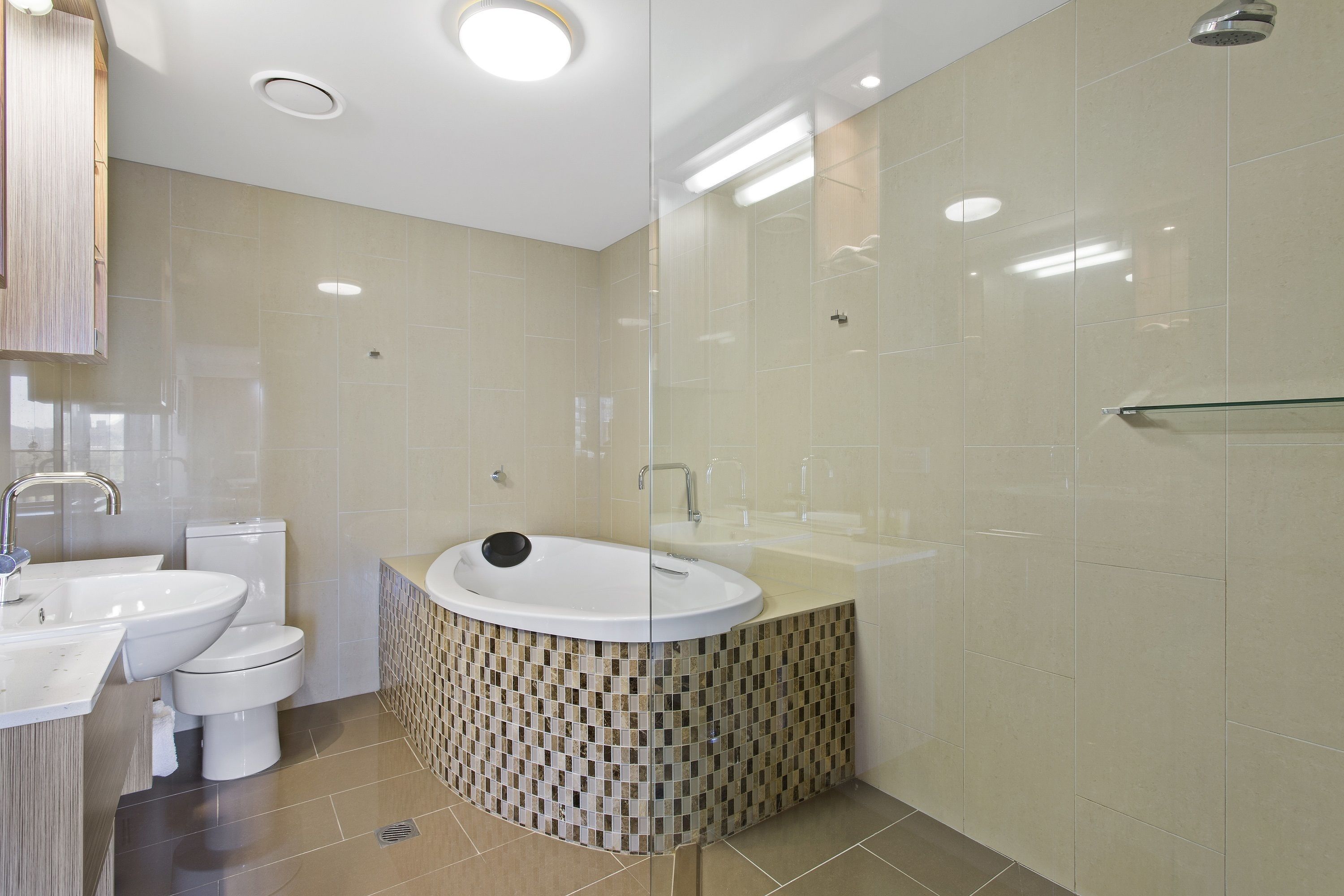 A modern bathroom with a freestanding bathtub, a toilet, and a sink.