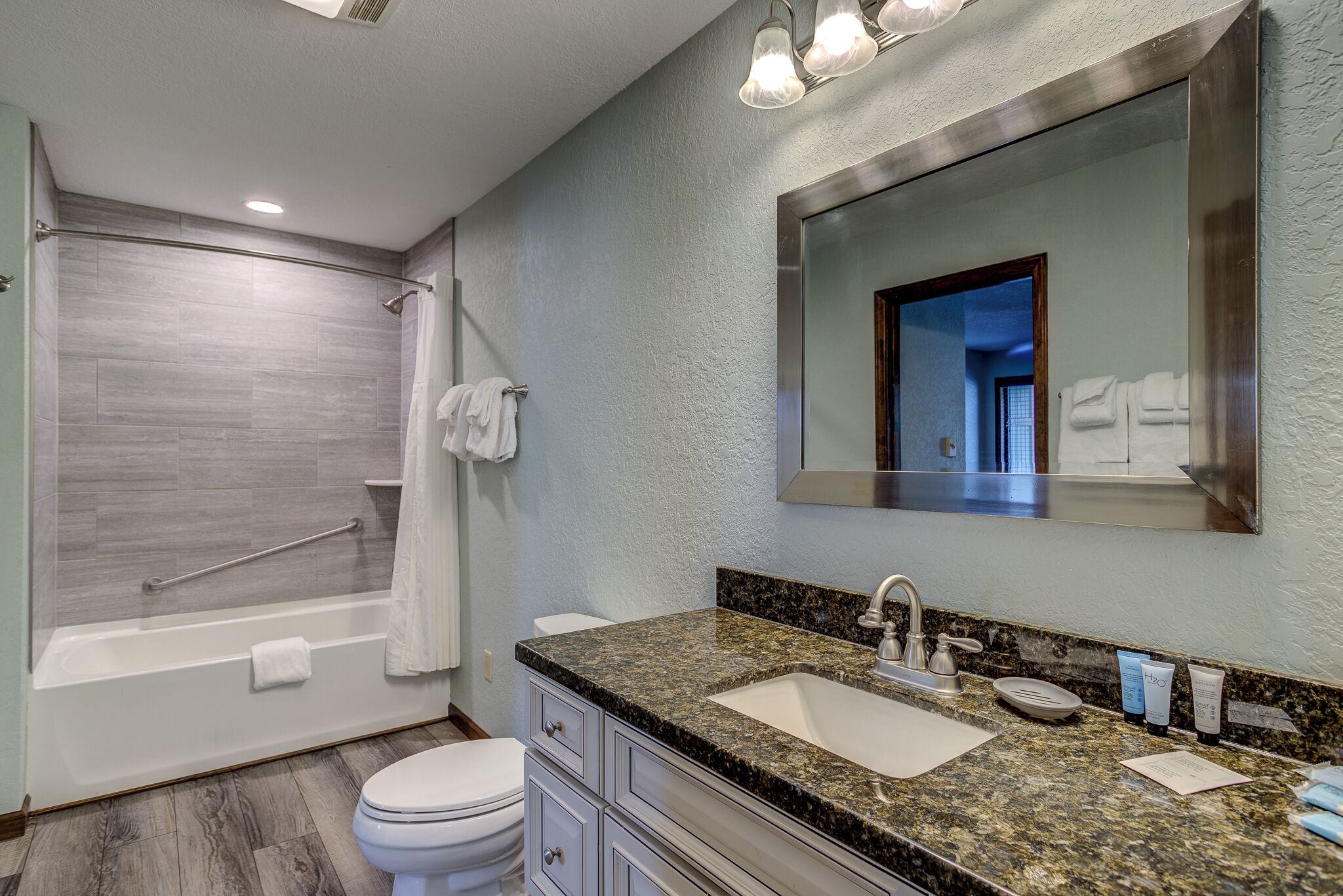 A modern bathroom with a bathtub, toilet, and sink.