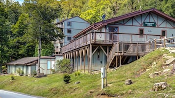 A two-story building with a 'Management Office' sign, wooden balconies, and a sloped roof.