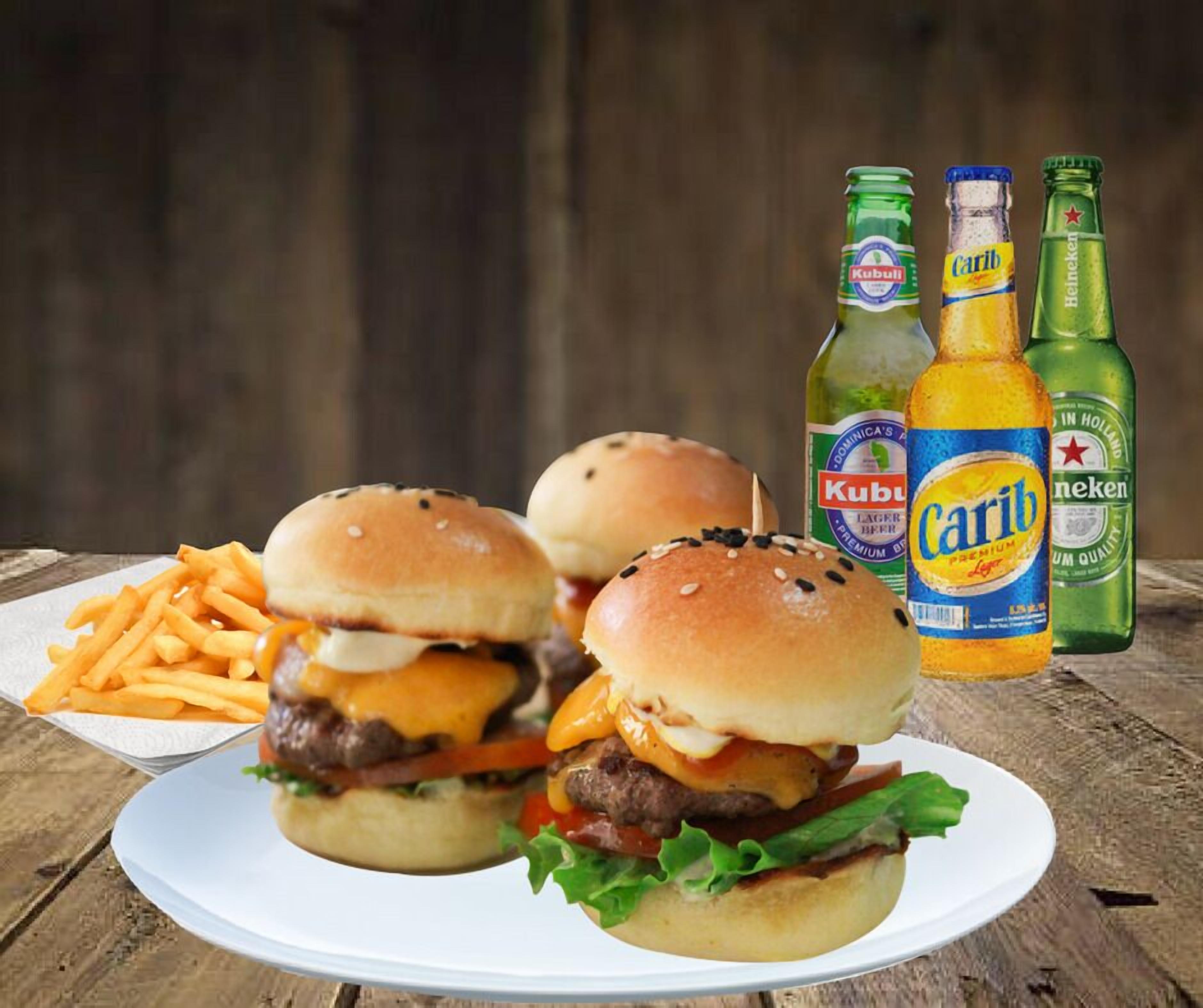 A plate with two burgers and fries, and three beer bottles.