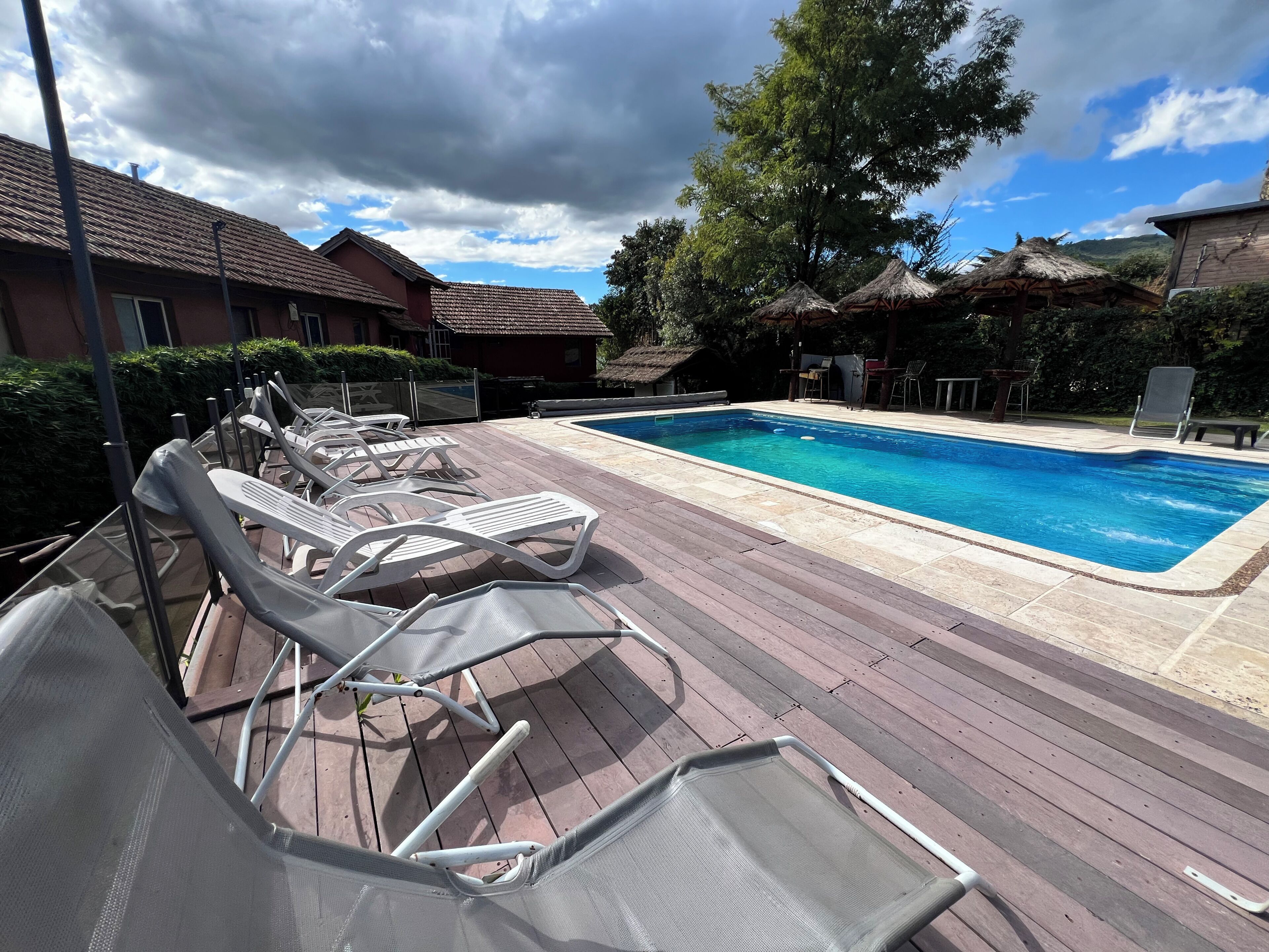 A poolside area with lounge chairs and a swimming pool.