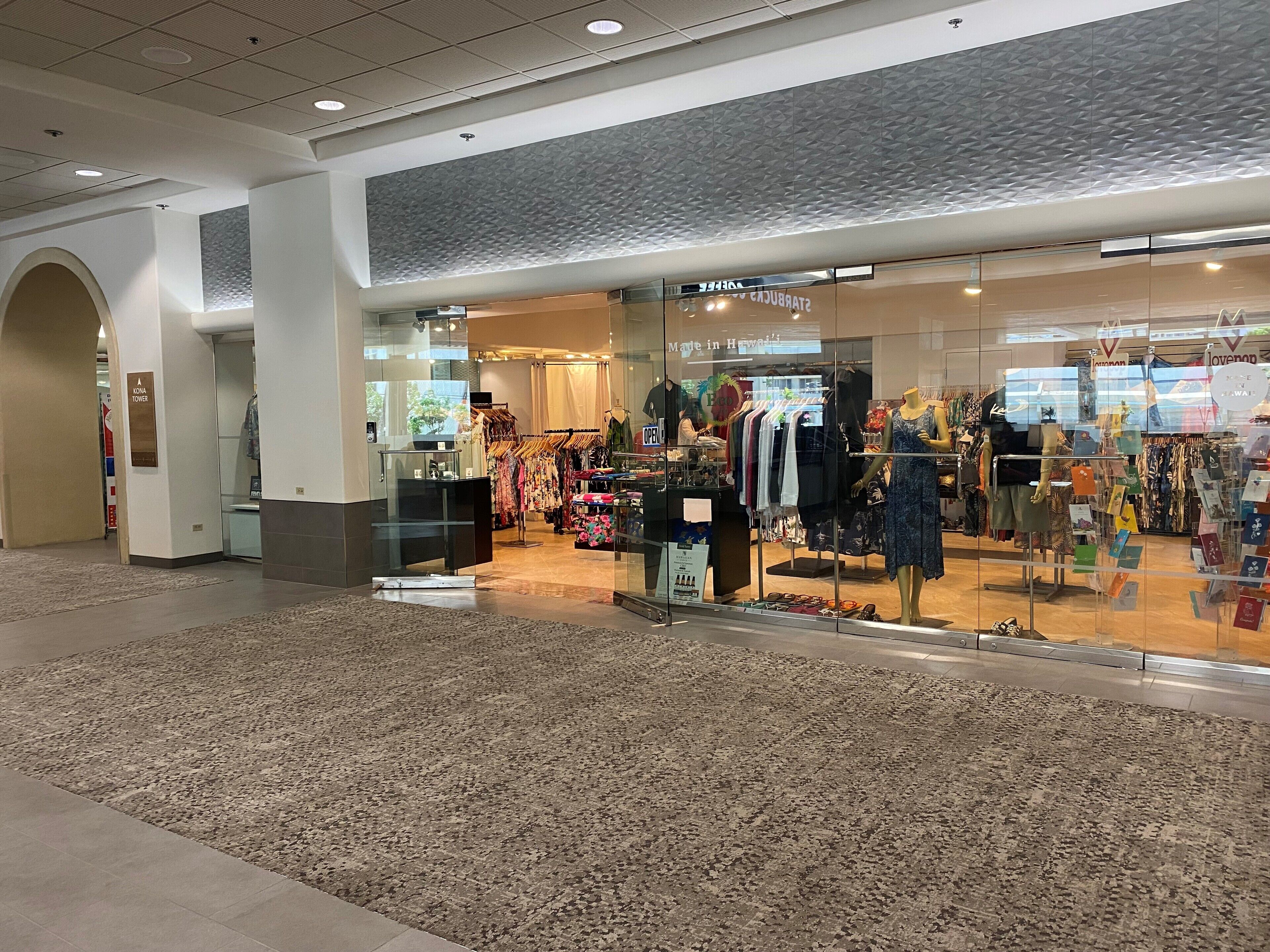 A clothing store with a variety of apparel on display, including dresses and casual wear.