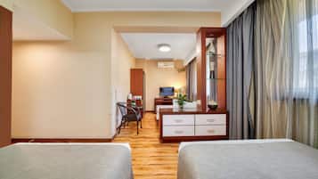 Standard Triple Room | In-room safe, desk, laptop workspace, blackout curtains