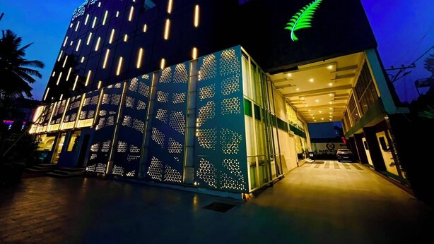 A modern hotel with a distinctive geometric facade and a prominent fern logo. - The Fern Residency Bengaluru, Yeshwanthpur, Series by Marriott (Bengaluru)