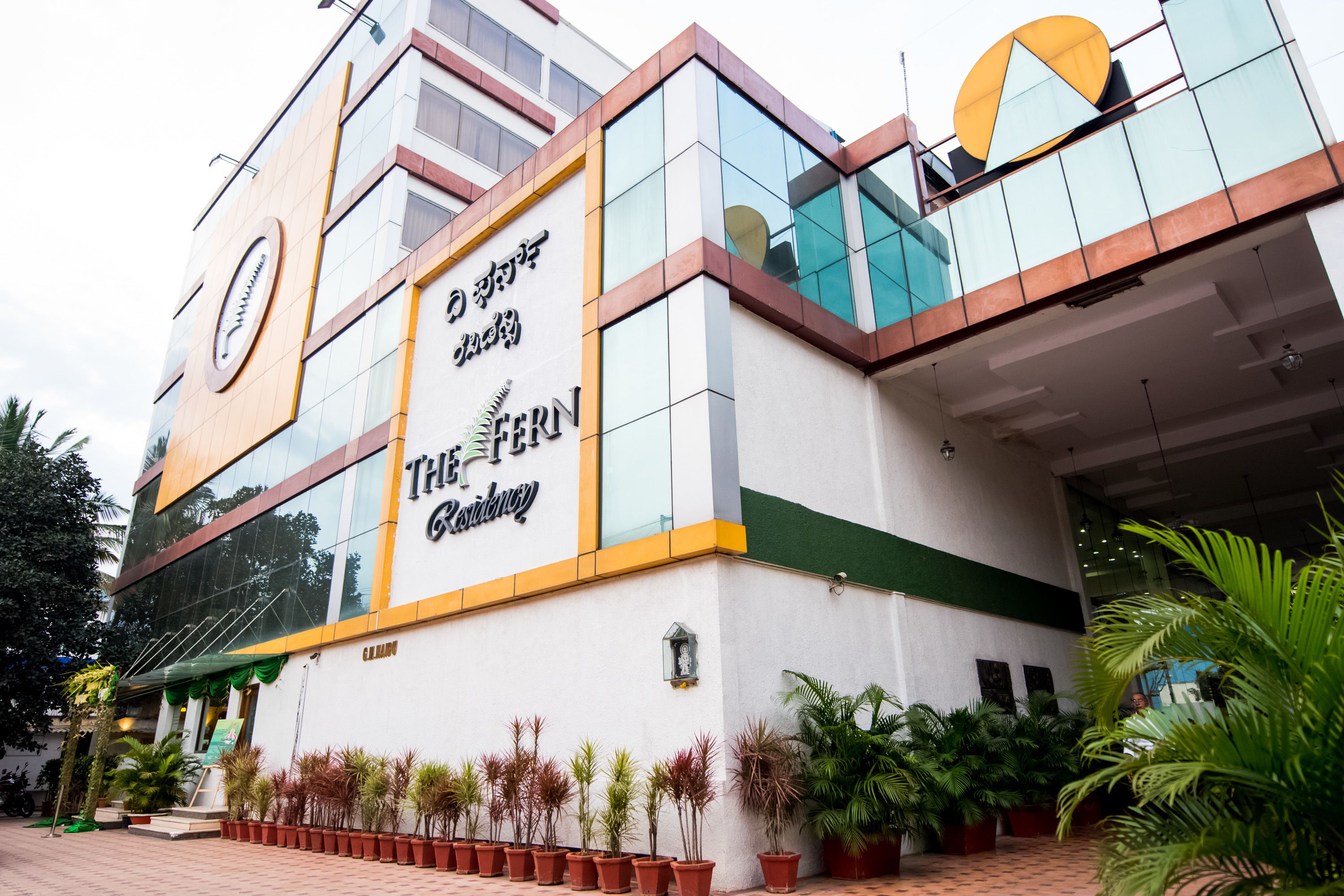A hotel with a modern facade, large windows, and a prominent sign.