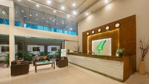 A spacious lobby with a reception desk, seating area, and large windows. - The Fern Residency Bengaluru, Yeshwanthpur, Series by Marriott (Bengaluru)