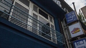 Un edificio con un letrero que dice "May Rooms".
