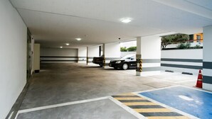 A multi-level parking garage with concrete floors and striped walls. - Hotel Maple (Jeju City)