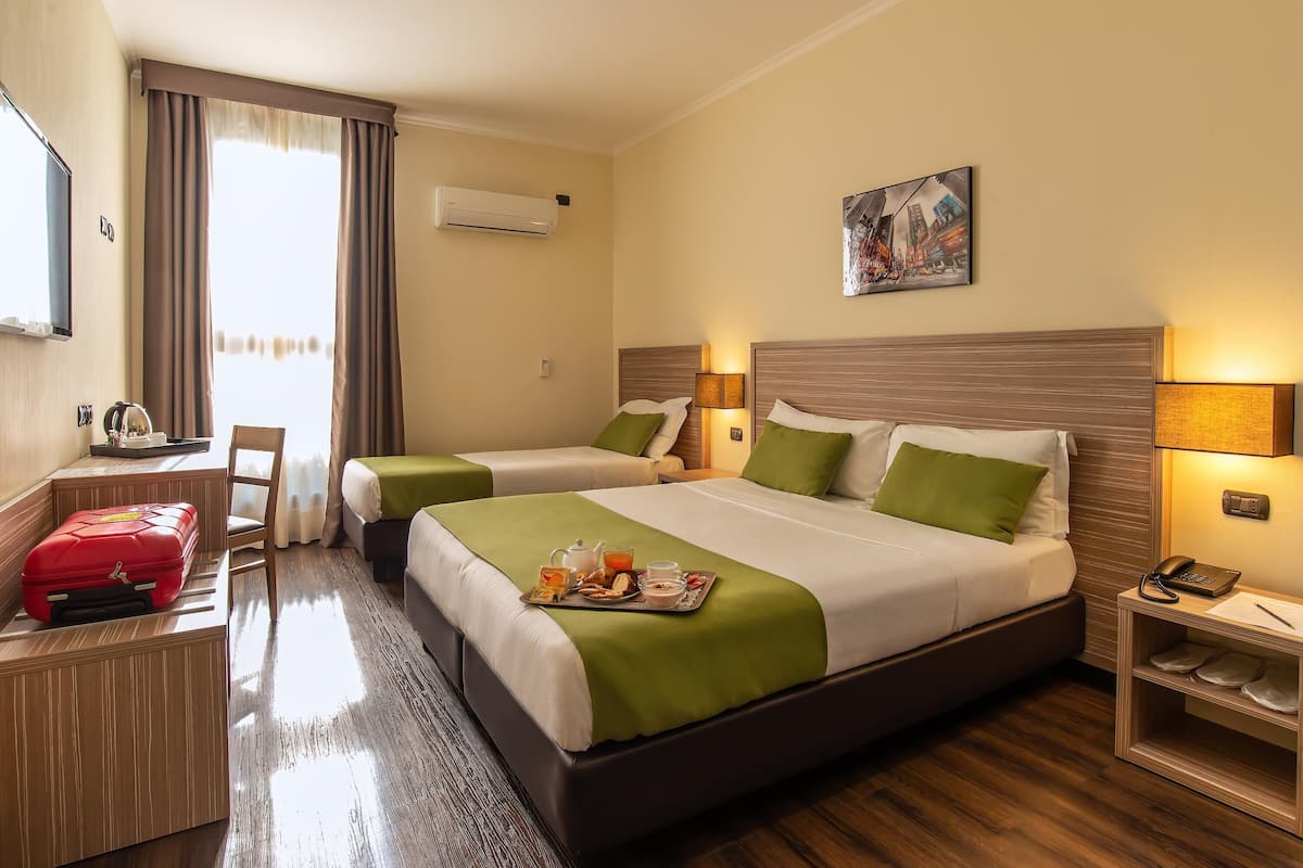 Superior Triple Room | Minibar, in-room safe, desk, laptop workspace