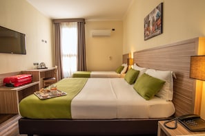 Superior Triple Room | Minibar, in-room safe, desk, laptop workspace