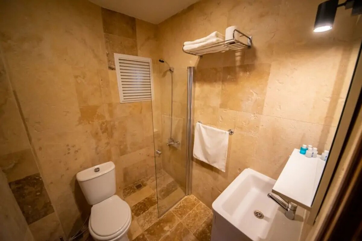 Un baño con inodoro, ducha y lavamanos.