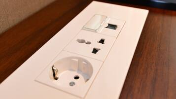 A power strip with multiple outlets and USB ports on a wooden surface.