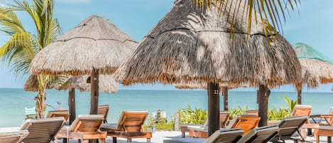 On the beach, white sand, sun-loungers