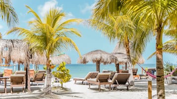 On the beach, white sand, sun loungers