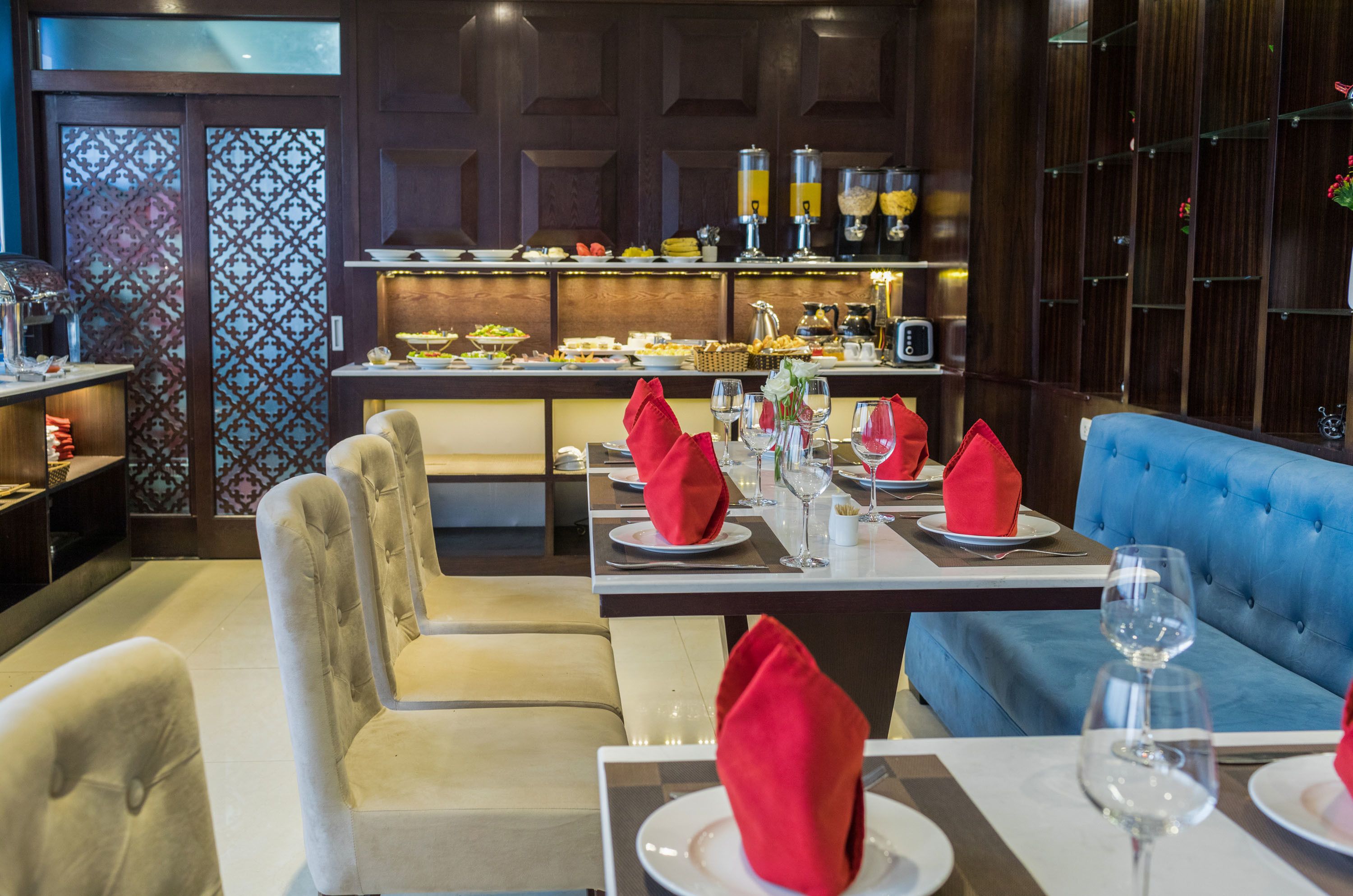 A restaurant with a buffet, seating area, and bar.