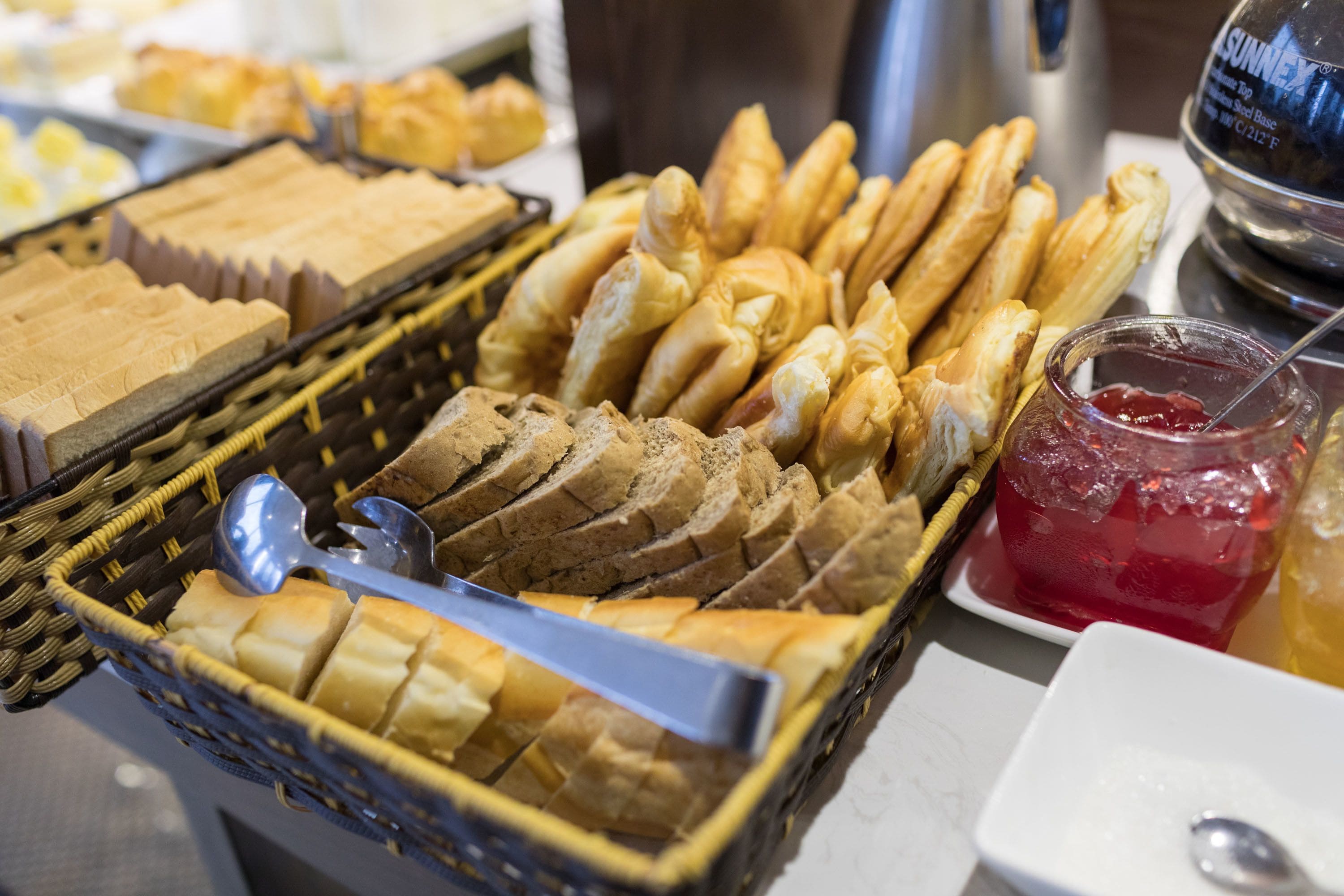 Un buffet proposant une variété de pains et de confitures.