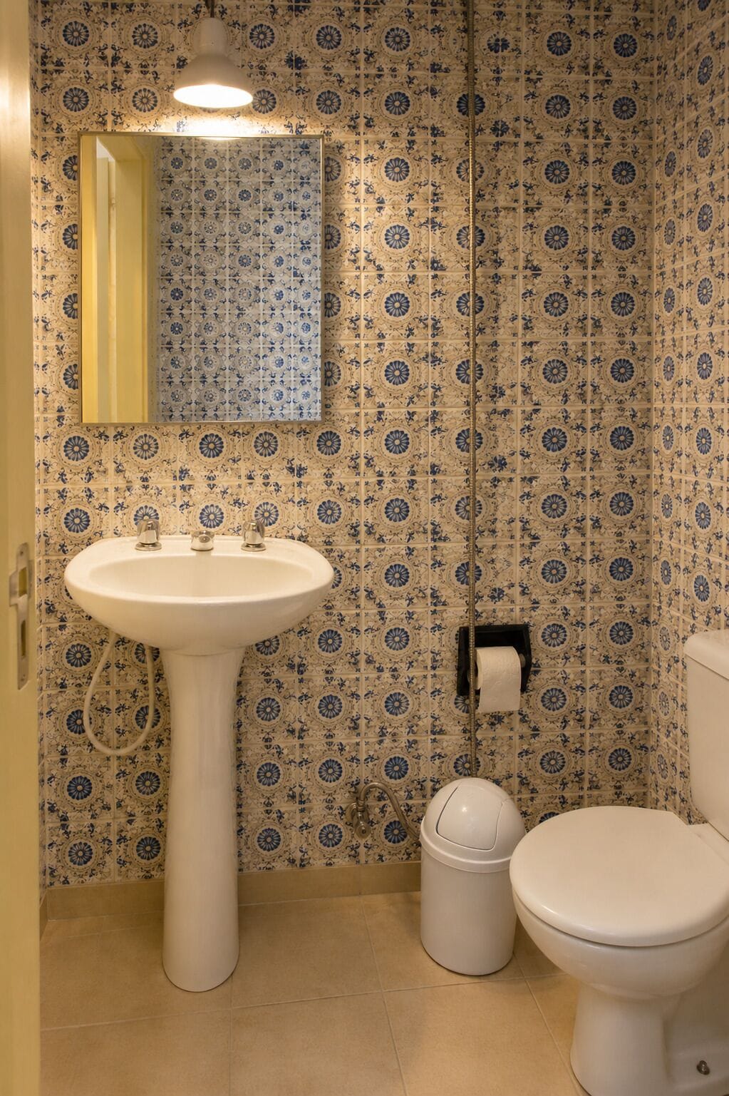 A bathroom with a sink, toilet, and a mirror.