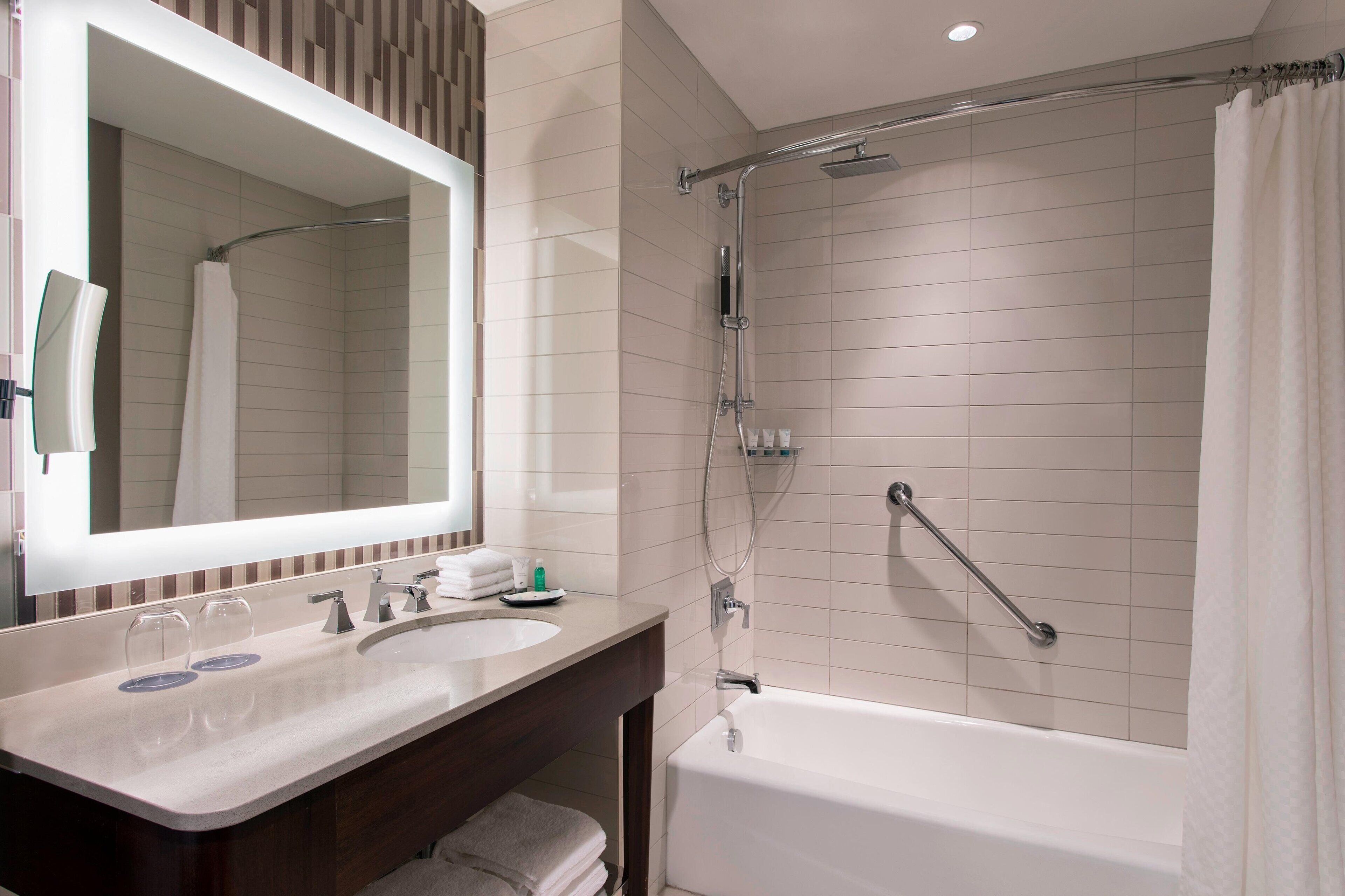 combined shower/bathtub, designer toiletries, hair dryer, bathrobes