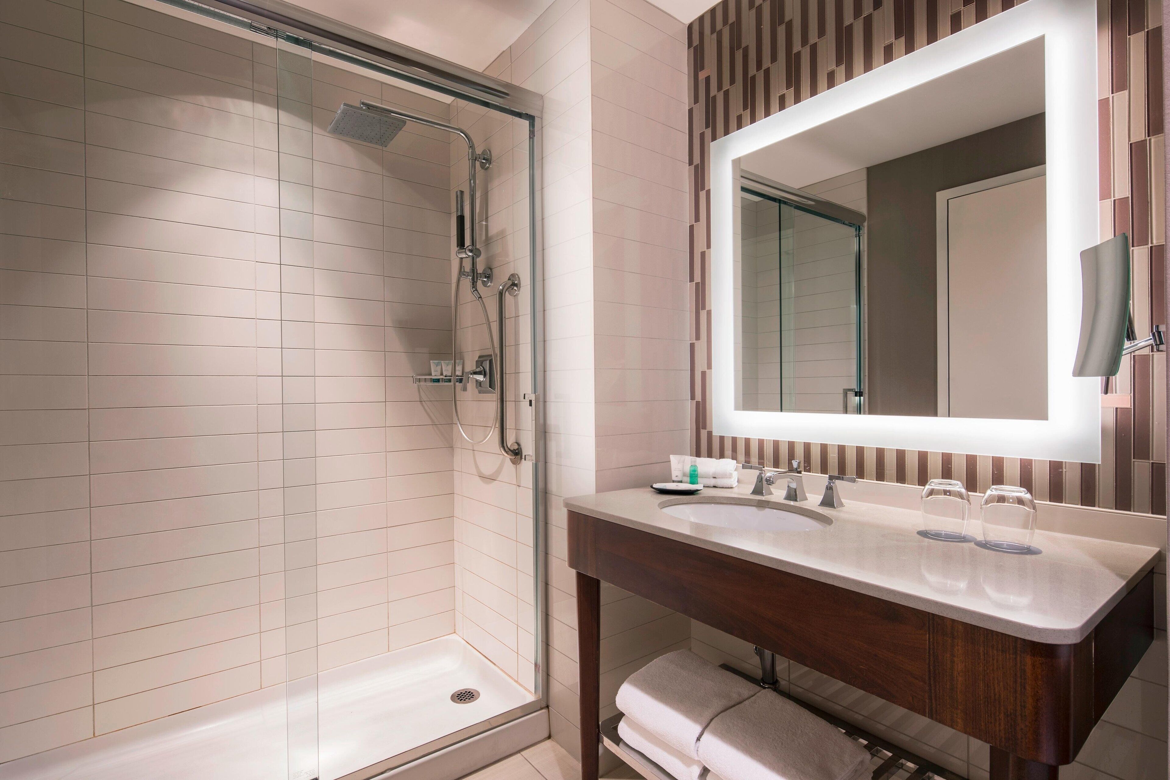 combined shower/bathtub, designer toiletries, hair dryer, bathrobes