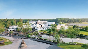 A large estate with multiple buildings, a pond, and outdoor seating areas. - Chateau Renault (Egg Harbor City)