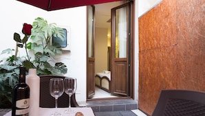 A table with a bottle of wine, two glasses, a rose, and a starfish. - Arcobaleno Rooms (Cagliari)