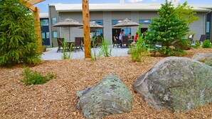 An outdoor patio area with wooden pergola, dining tables, and chairs. - Best Western Pembroke Inn & Conference Centre (Pembroke)
