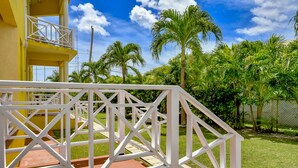 A white metal staircase leading to a yellow building with a balcony. - Best E Villas Prospect (Prospect)