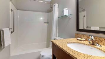 A modern bathroom with a bathtub, toilet, and sink.