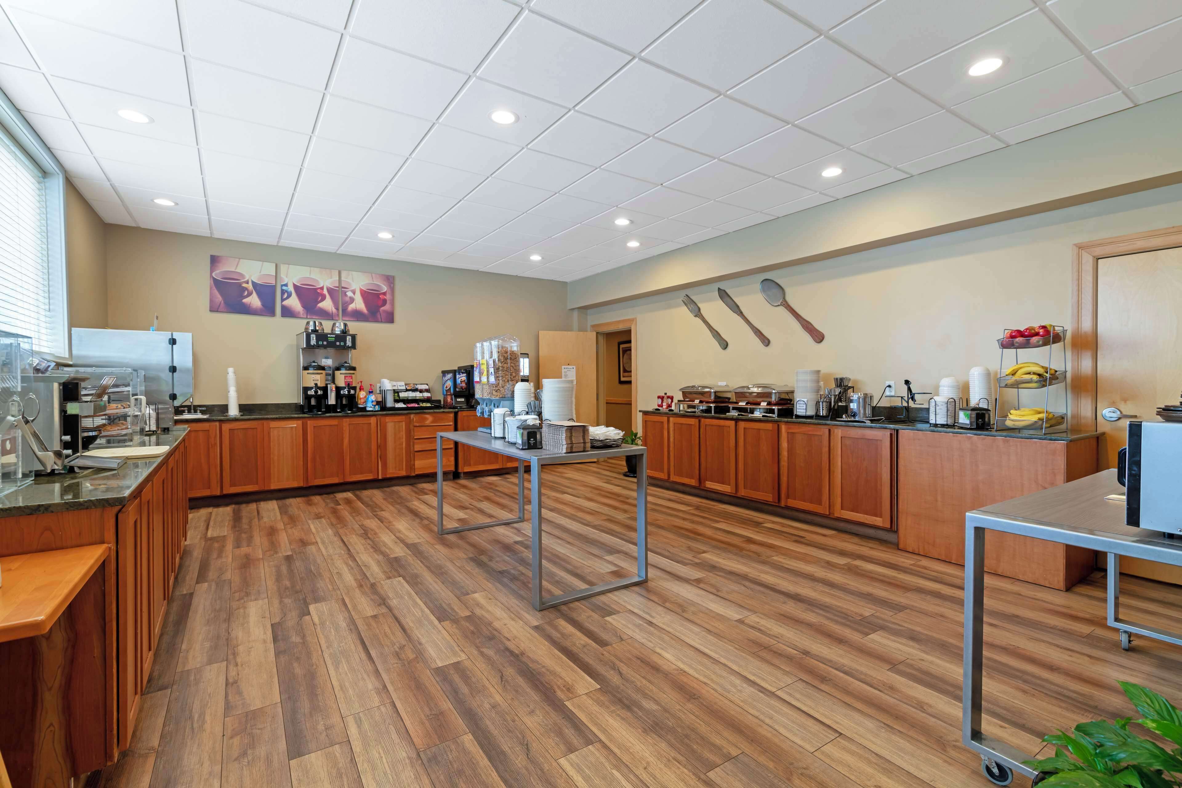 A spacious kitchen with wooden cabinets, a central island, and various appliances.