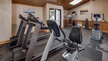 A gym with treadmills, an elliptical, and weight machines.