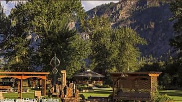 Reception and party facilities with a gazebo, pergola, and outdoor seating area in a mountainous landscape.