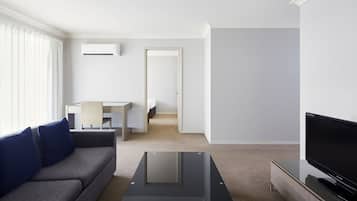Two Bedroom Deluxe Apartment | Living area | 30-inch LCD TV with premium channels, TV