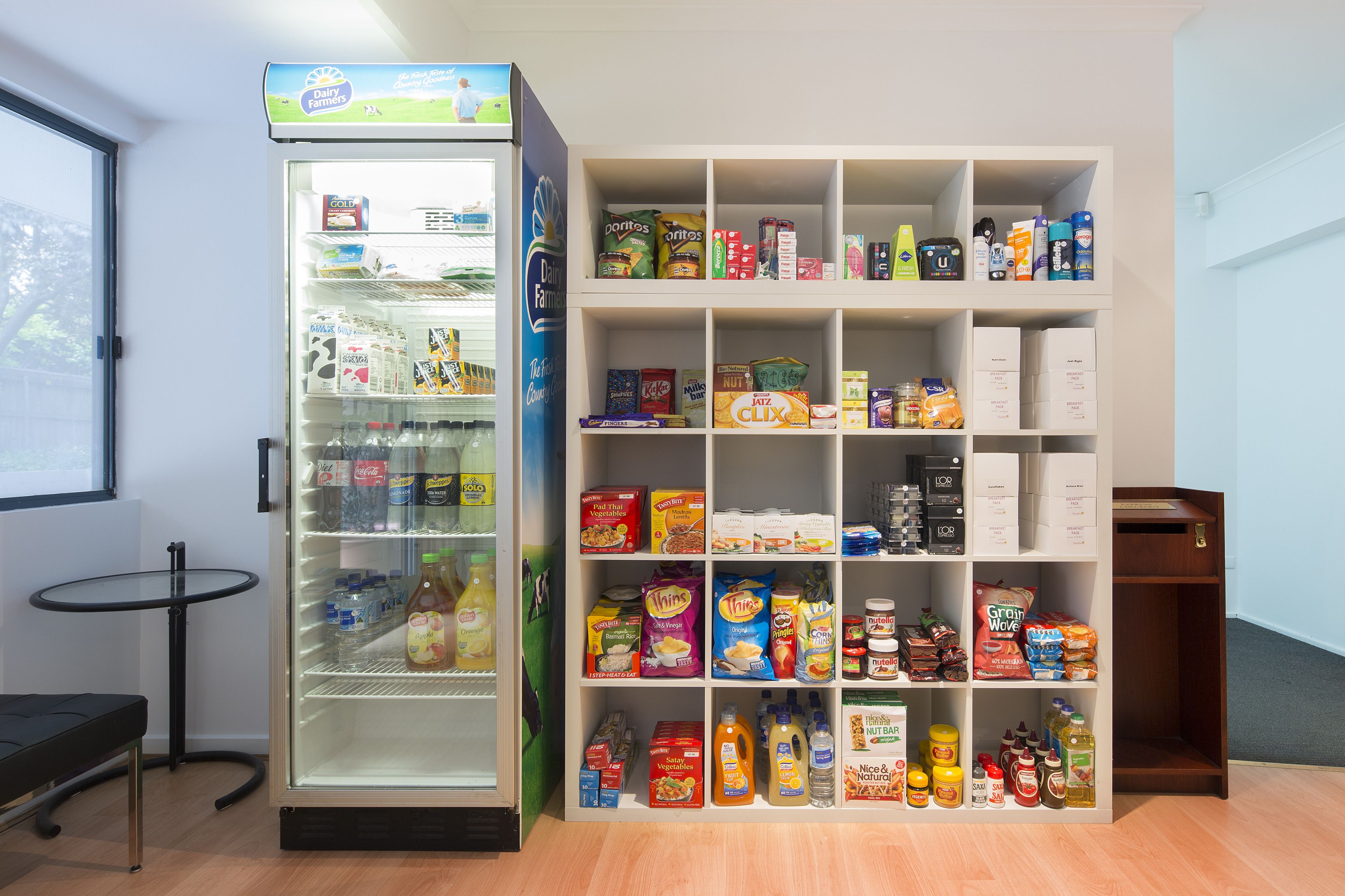 A refrigerated display and a shelf stocked with various food items.